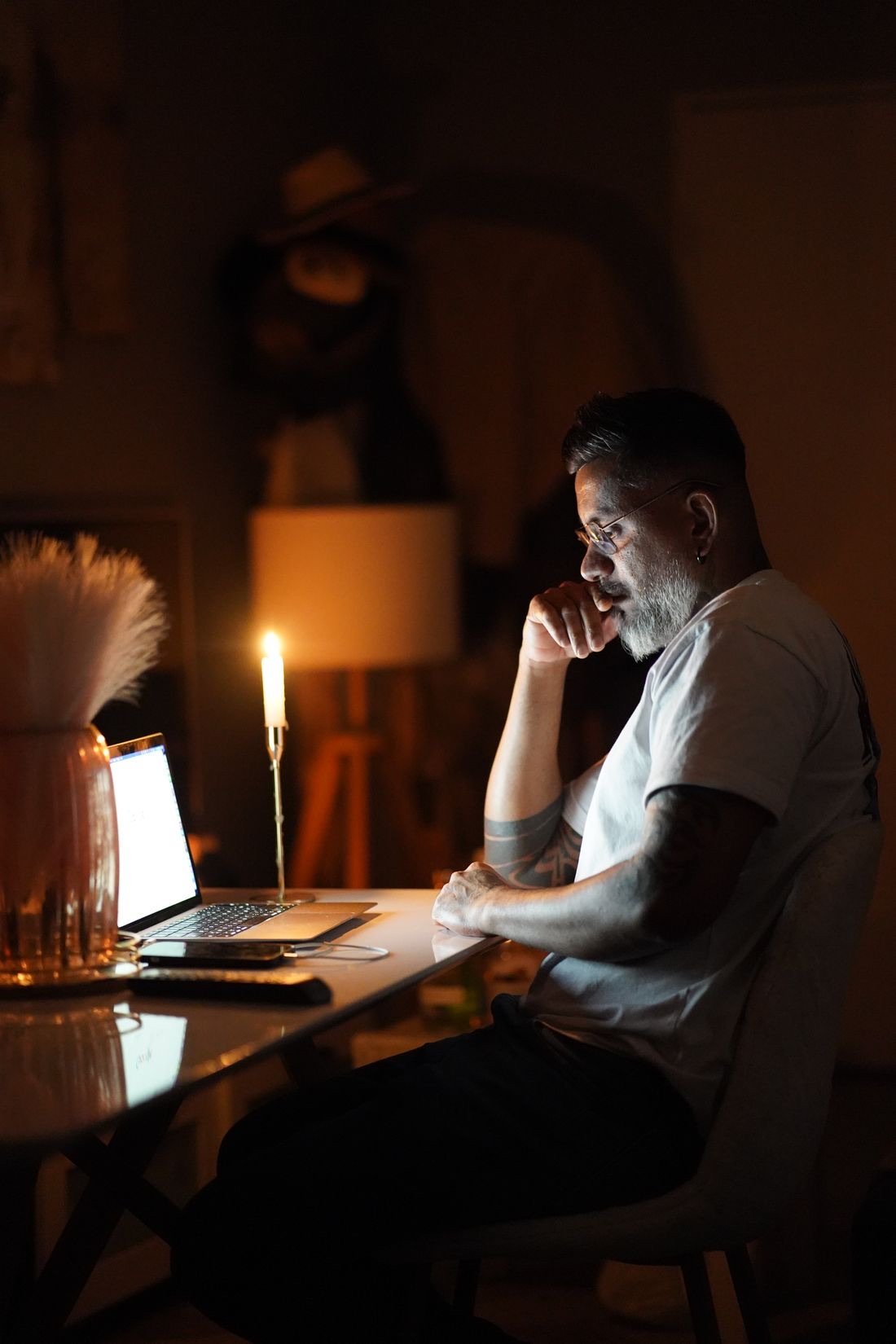 Founder reviewing a project late at night by candlelight