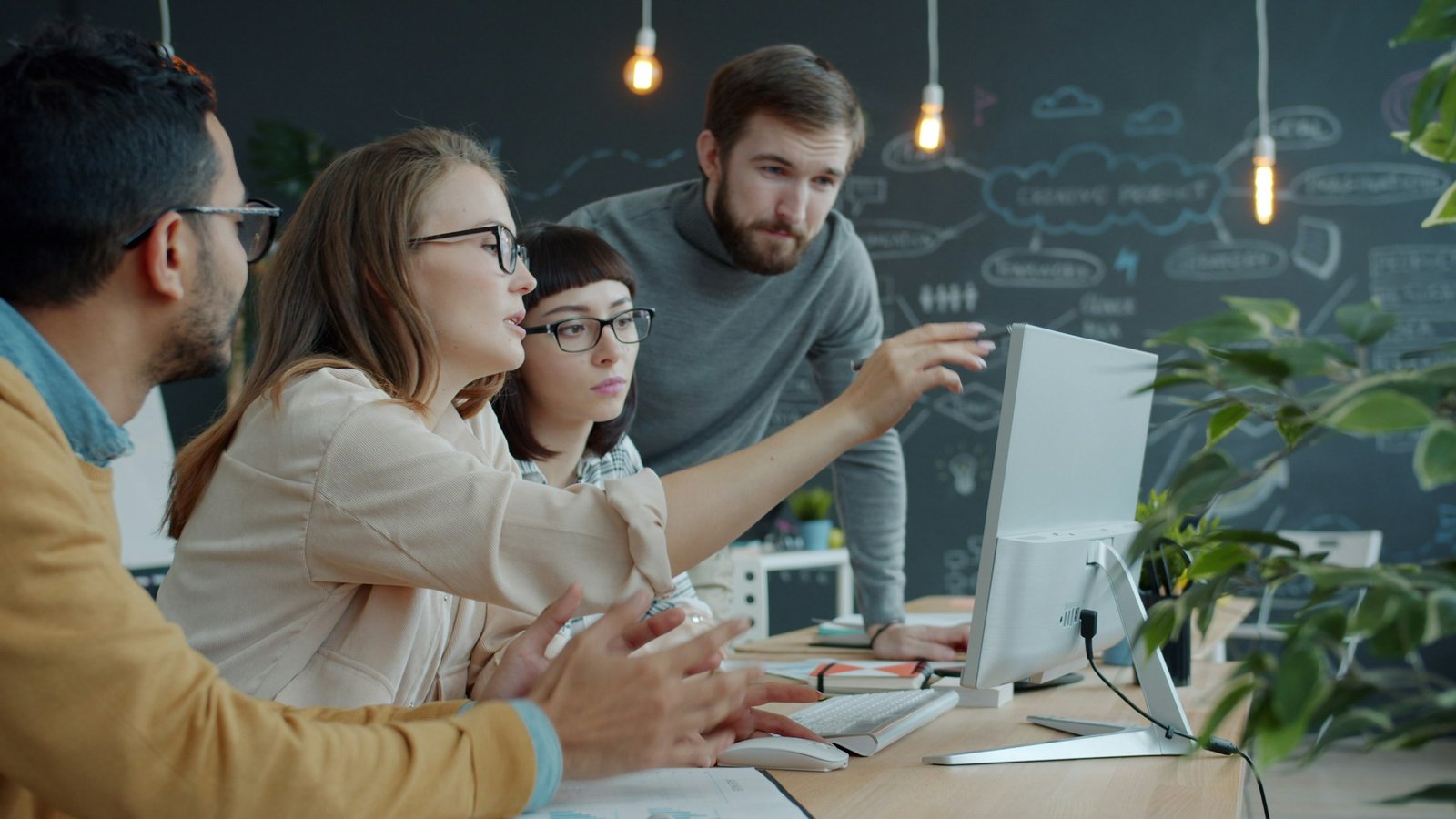Delivery team reviewing work together at a shared screen